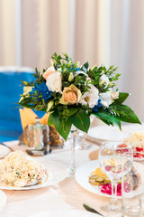 Flower table decorations for holidays and wedding dinner. Table set for holiday, event, party or wedding reception in restaurant