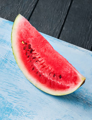Fototapeta na wymiar cut of watermelon on blue background. Top view.