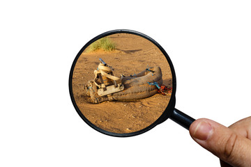saddle for camel on the sand, view through a magnifying glass on a white background, magnifying...