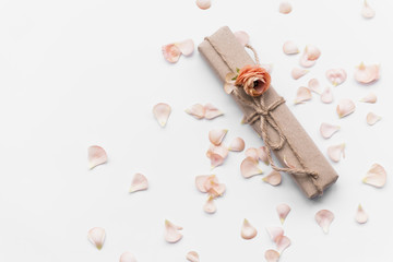 Gift box with flower among petals