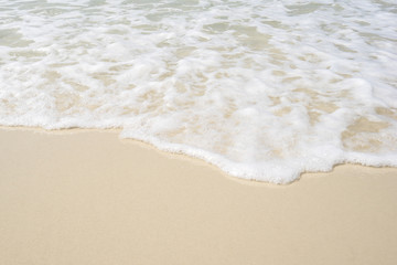 Fototapeta na wymiar Soft wave of sea on the sandy beach.