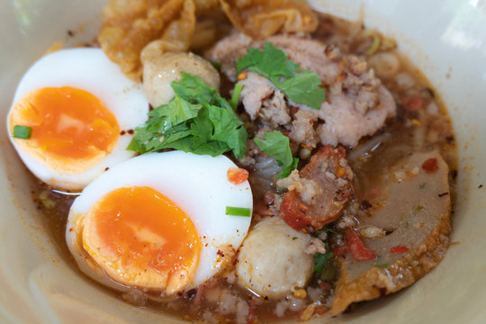 Noodle tom yum with pork and egg .