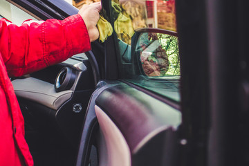 Car detailing - the man holds the microfiber in hand and polishes the car.