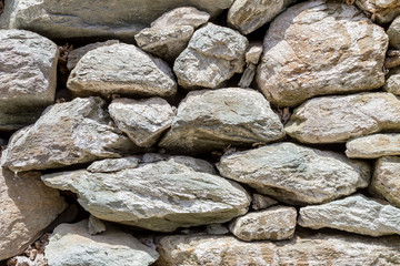 The background old gray stony wall