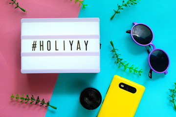 light box with word HOLIYAY on colorful background