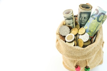 money in different currencies in a bag with copy space on the right