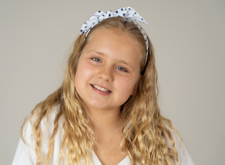 Portrait of a beautiful happy girl posing confident for the camera. Children happiness