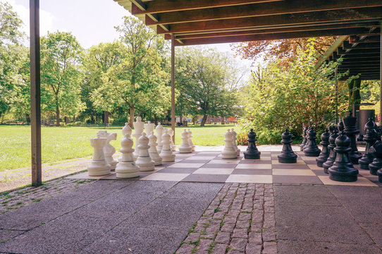 Large chess pieces in a city park.