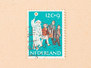 Fototapeta na wymiar THE NETHERLANDS 1970: A stamp printed in the Netherlands shows people crossing a road, circa 1970
