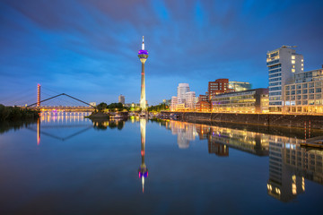 Fototapeta na wymiar Dusseldorf, Germany. Cityscape image of Düsseldorf, Germany with the Media Harbour and reflection of the city in the Rhine river, during twilight blue hour.