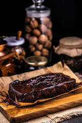 Brownie in chocolate syrup on baking paper.