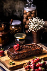Brownie in chocolate syrup with strawberries