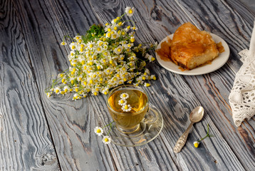 Chamomile tea on a wooden table