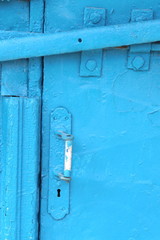 Old white door knob on old blue background