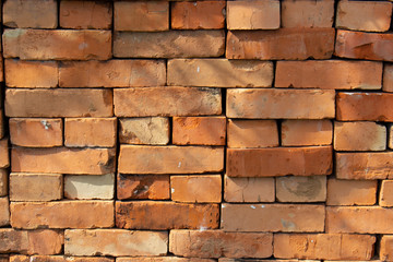 Red brick stack, background texture pattern. A pile of bricks material for construction.