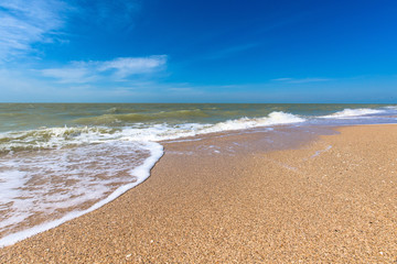 sea white wave on the sand hall. blue sea and sky