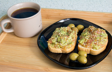 Coffee and sandwich with guacamole
