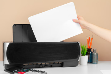 Woman using the printer to scanning and printing document
