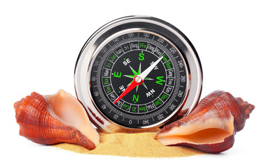 sea shells and old compass with sand isolated on white background