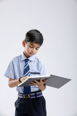 Indian / Asian school boy with note book and studying 