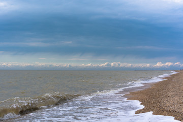 sea wave foam sand gold color. close-up , blue sky
