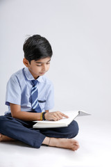 Indian / Asian school boy with note book and studying 