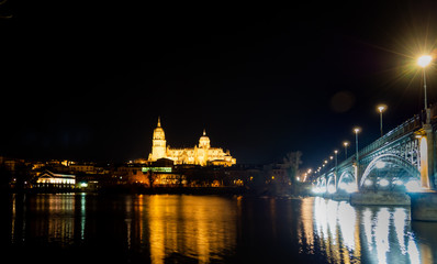 Obraz na płótnie Canvas Long exposure night view of the Cathedral and Enrique Estevan bridge in Salamanca (Spain)