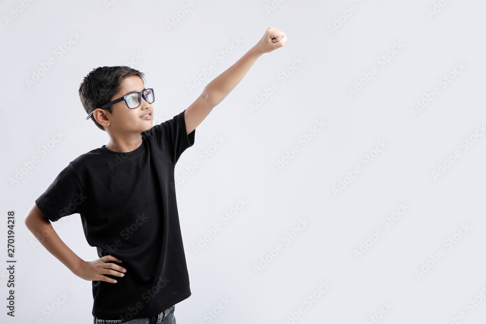 Wall mural little indian boy in a superman pose