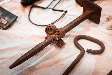 Close up shot of torturing equipment in ancient castle. Rusty heavy tools, Medieval culture and...