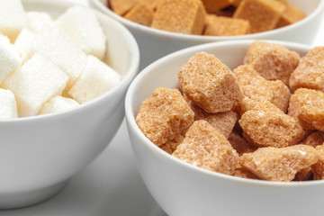 White refined sugar and brown unrefined sugar cubes