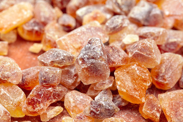 brown sugar rock organic crystalline close up on dark background