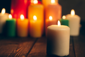 candles burning in darkness over black background. commemoration concept.