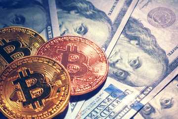 Golden bitcoin coins on a paper dollars money