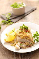 cooked fish with a crust and herbs