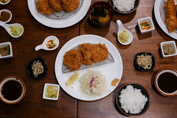 Top View , Homemade Japanese deep fried breaded pork tenderloin with shredded cabbage dipped with tonkatsu sauce. Japanese Food