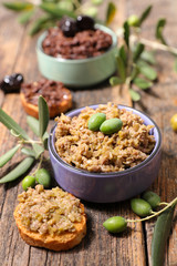 olive tapenade and toast on wood background