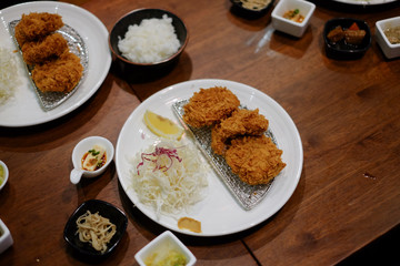 Top View , Homemade Japanese deep fried breaded pork tenderloin with shredded cabbage dipped with tonkatsu sauce. Japanese Food