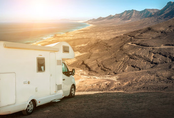 White travel caravan car stay on the beautifull ocean coastline