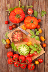 colorful tomato and basil with board and knife