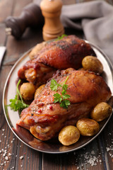 roasted duck and potatoes with herbs