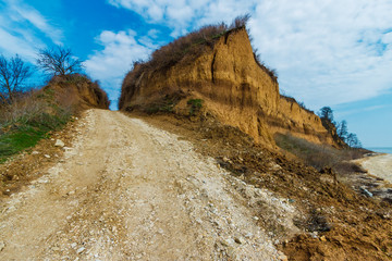 The ground road leading upward through steep clay cliffs. Russia, Azov sea, Taganrog bay
