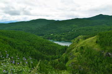 Fototapeta na wymiar Mountain lake among green hills.