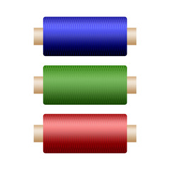 Three colored coils with thread to repair clothing on a white background
