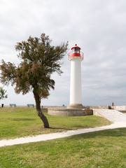 Fototapeta na wymiar Ile de Re in France lighthouse for boats in harbor of Saint Martin village