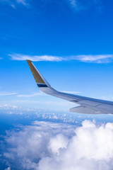 Bussiness and travel concept. Aerial view through window inside aircraft cabin with beautiful blue sky and cloud with sunlight, copy space, top view