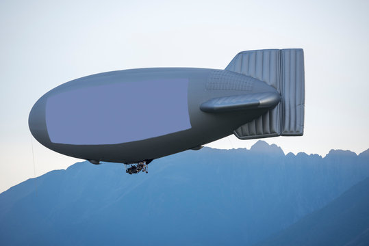 Flying Blimb with Copy Space and Mountain in Switzerland.