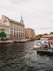 Embankment in Saint Petersburg pass a tour boat with tours all over the facades of historic buildings