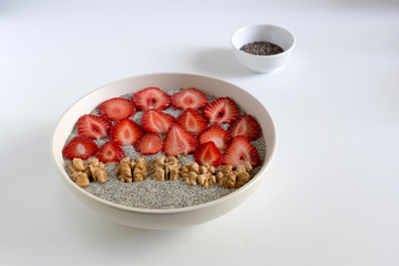 Chia seeds with oatmeal, strawberries and walnuts.