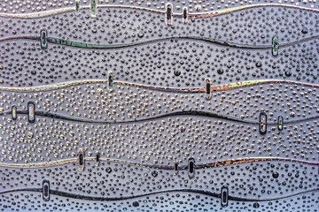 Blue porcelain tile with a wavy pattern and circles of different colors and sizes.