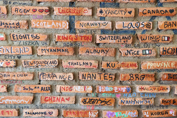  Close up part of wall with bricks signed all torists visited that place. Laos, Van Vieng wall